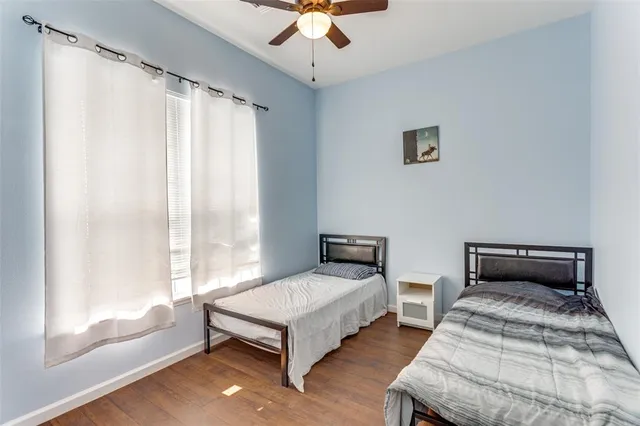 a bedroom with two beds and a chandelier