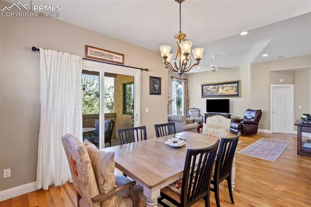 a view of a dining room with furniture wooden floor and chandelier