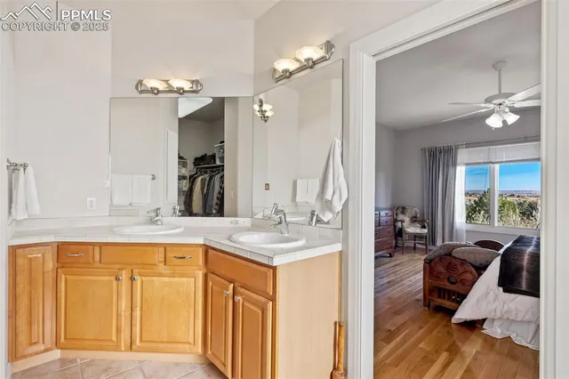 a spacious bathroom with a granite countertop sink a mirror and a bathtub