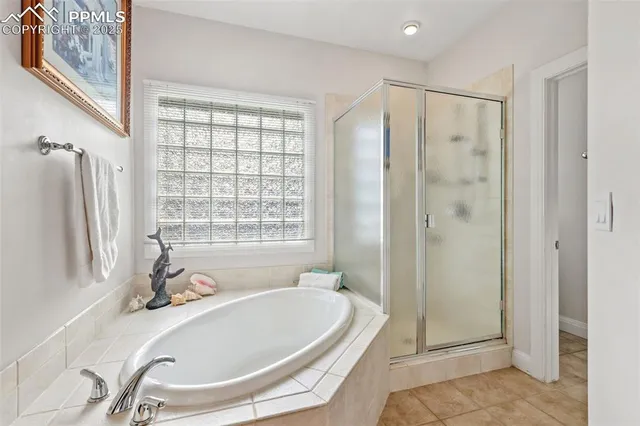 a bathroom with a tub a sink and a shower