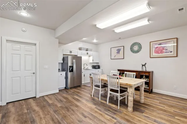 a view of a dining room with furniture and wooden floor