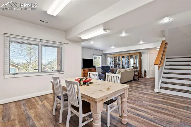 a view of a dining room with furniture and wooden floor