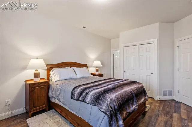 a bedroom with a bed and a lamp