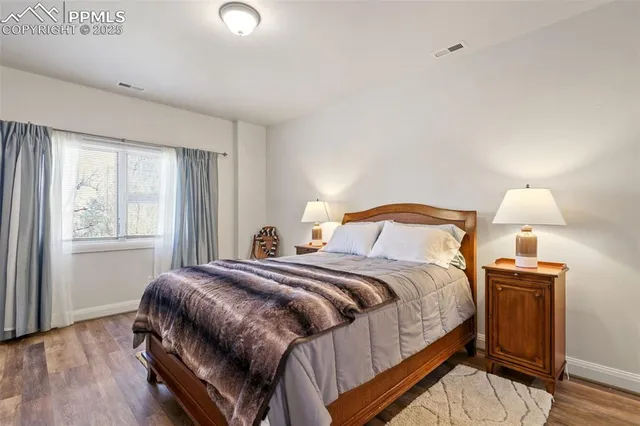 a bedroom with a bed and a lamp next to a window