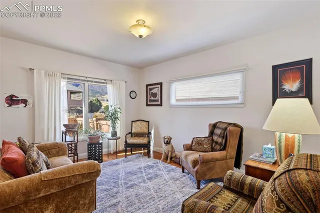 a living room with furniture and a lamp