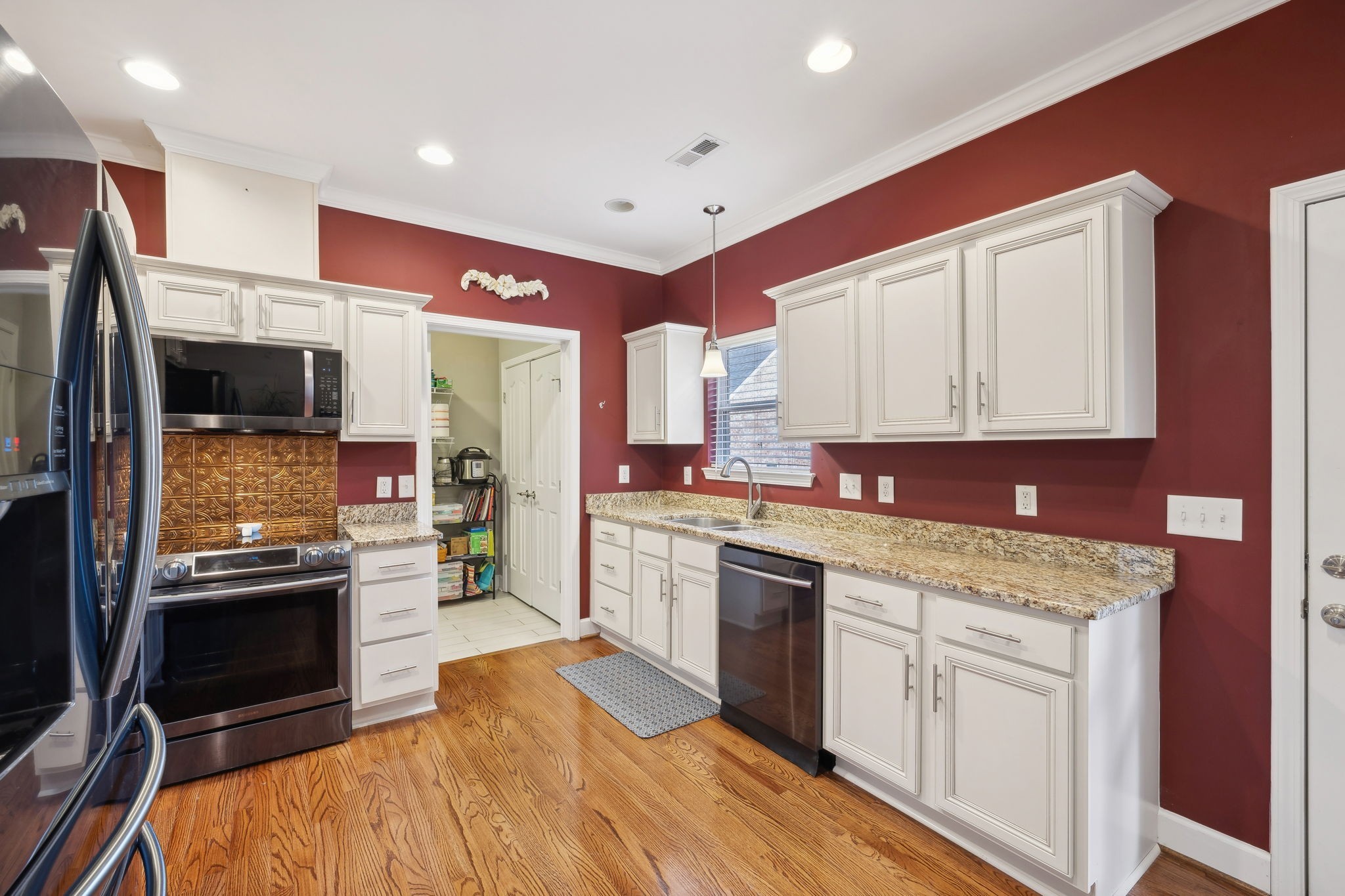 7126 Fernvale Springs Way Fairview, TN 37062 - Photo 14 of 35 a kitchen with stainless steel appliances granite countertop a stove top oven a sink and a refrigerator