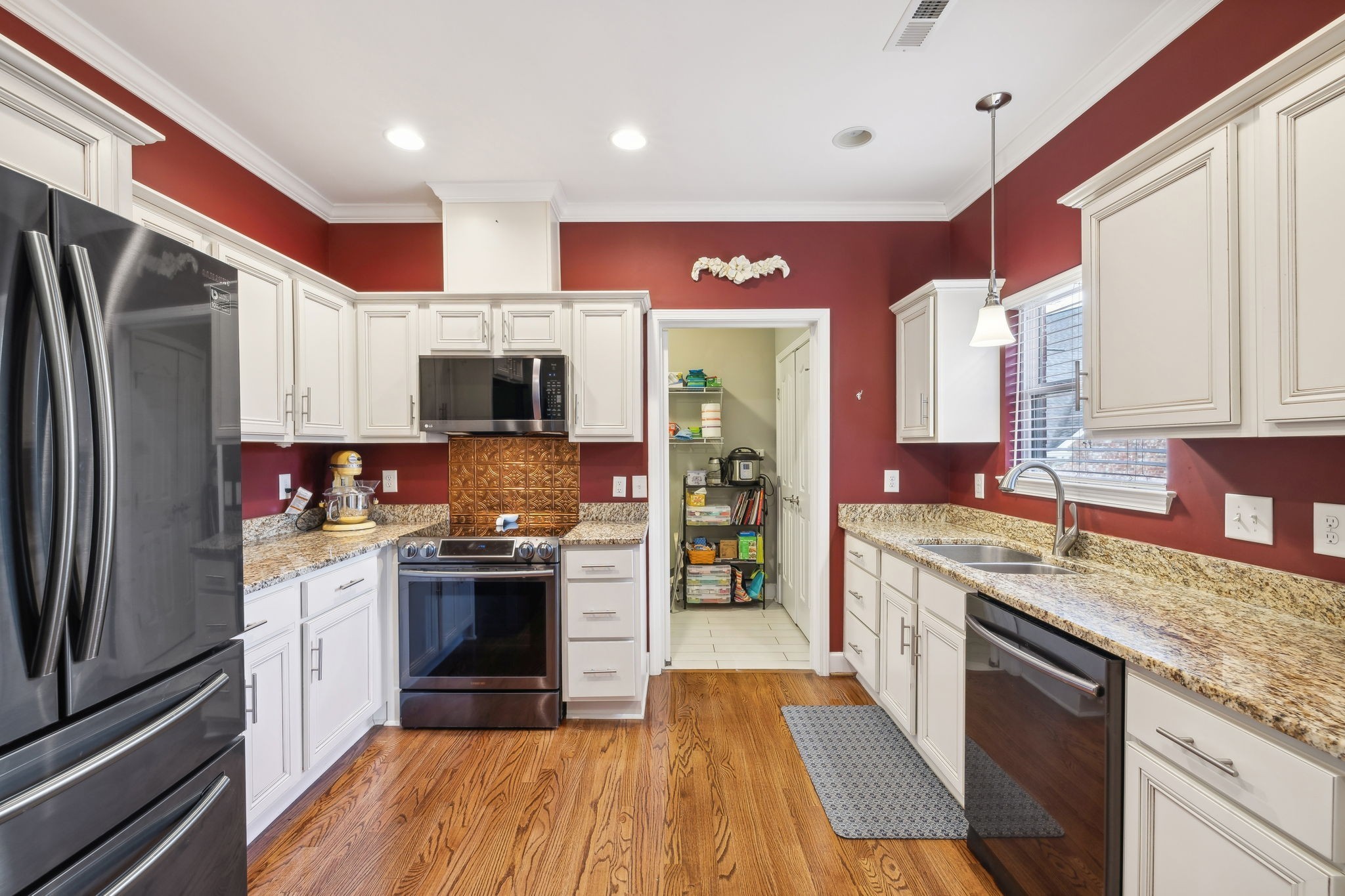 7126 Fernvale Springs Way Fairview, TN 37062 - Photo 15 of 35 a kitchen with stainless steel appliances granite countertop a stove top oven a sink and a refrigerator