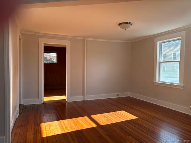 a view of a room with wooden floor and chair