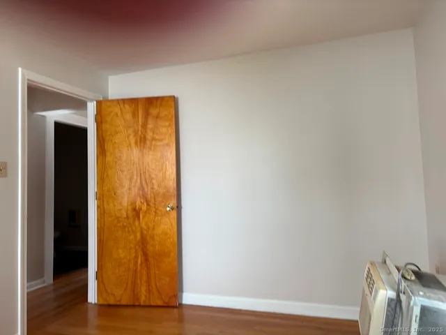a view of front door with wooden floor