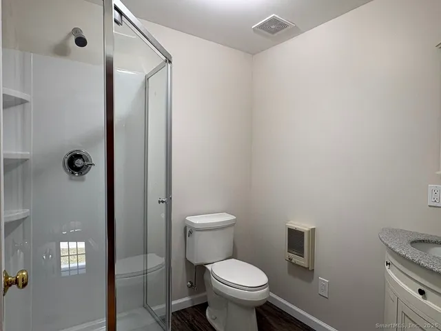 a bathroom with a toilet and a shower