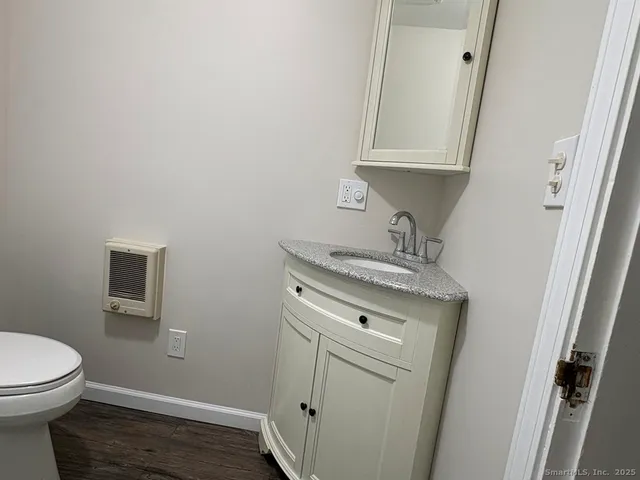 a bathroom with a sink a toilet and vanity