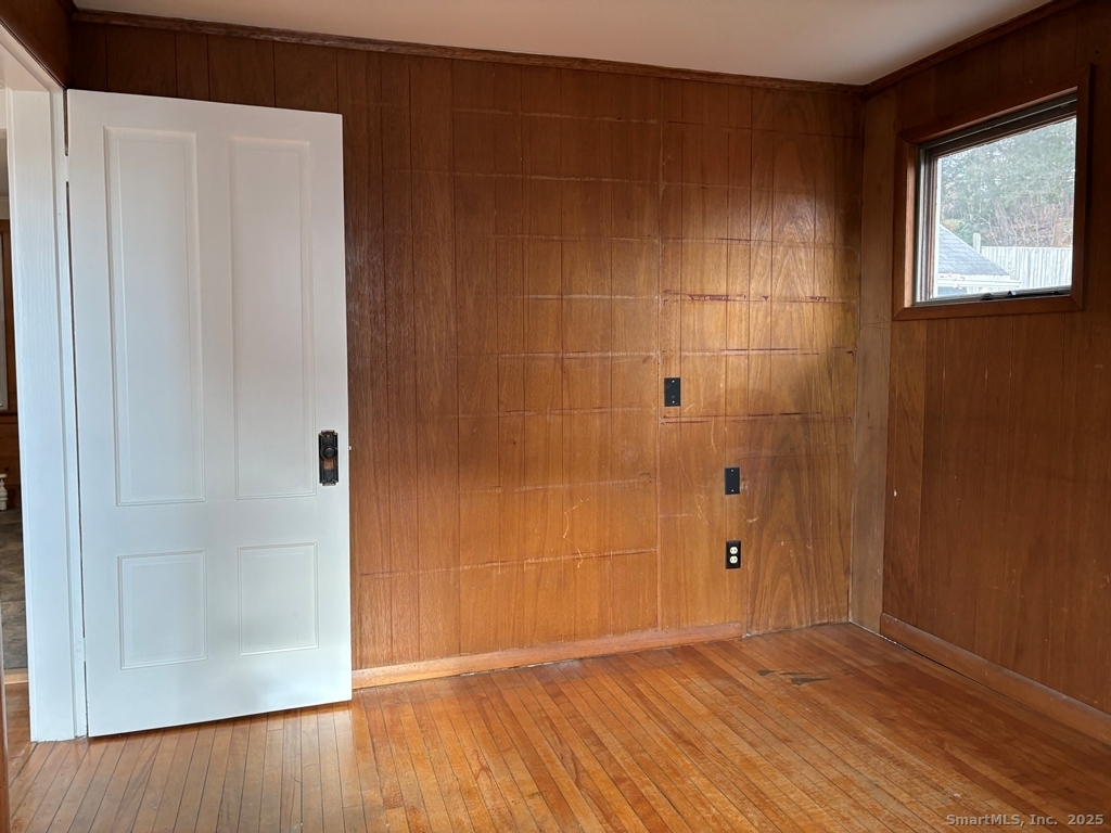 16 Tracy Street Thomaston, CT 06787 - Photo 7 of 26 a view of an empty room with wooden floor and a window