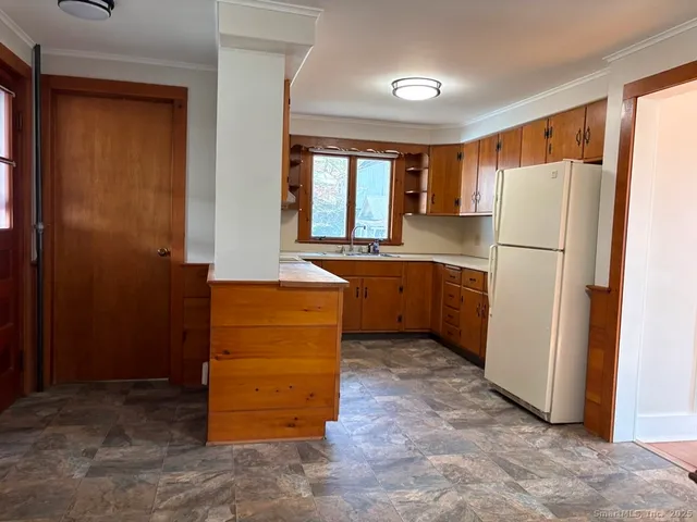 a kitchen with a refrigerator and window