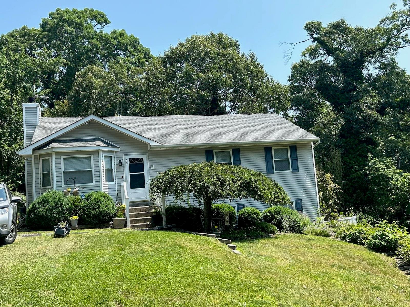 60 Aloma Road Rocky Point, NY 11778 - Photo 1 of 34 a front view of a house with a garden
