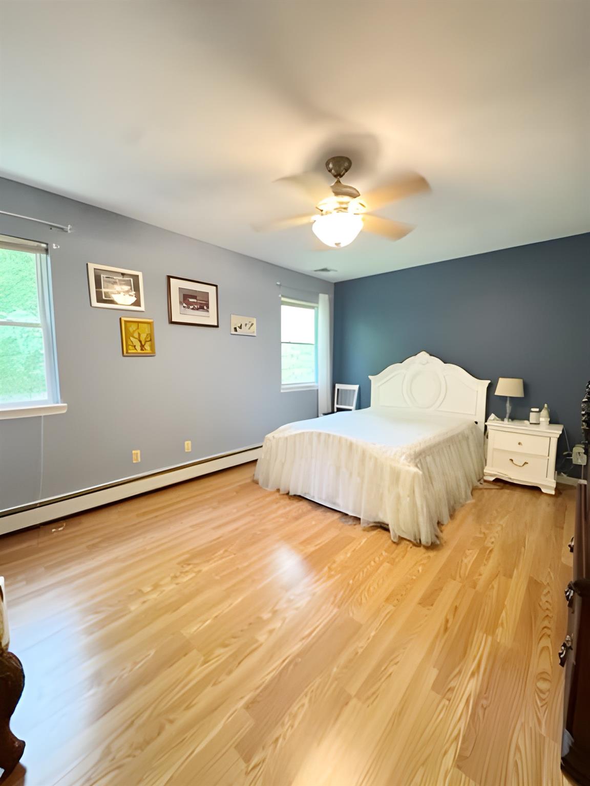 60 Aloma Road Rocky Point, NY 11778 - Photo 16 of 34 a bedroom with a large bed and a chandelier