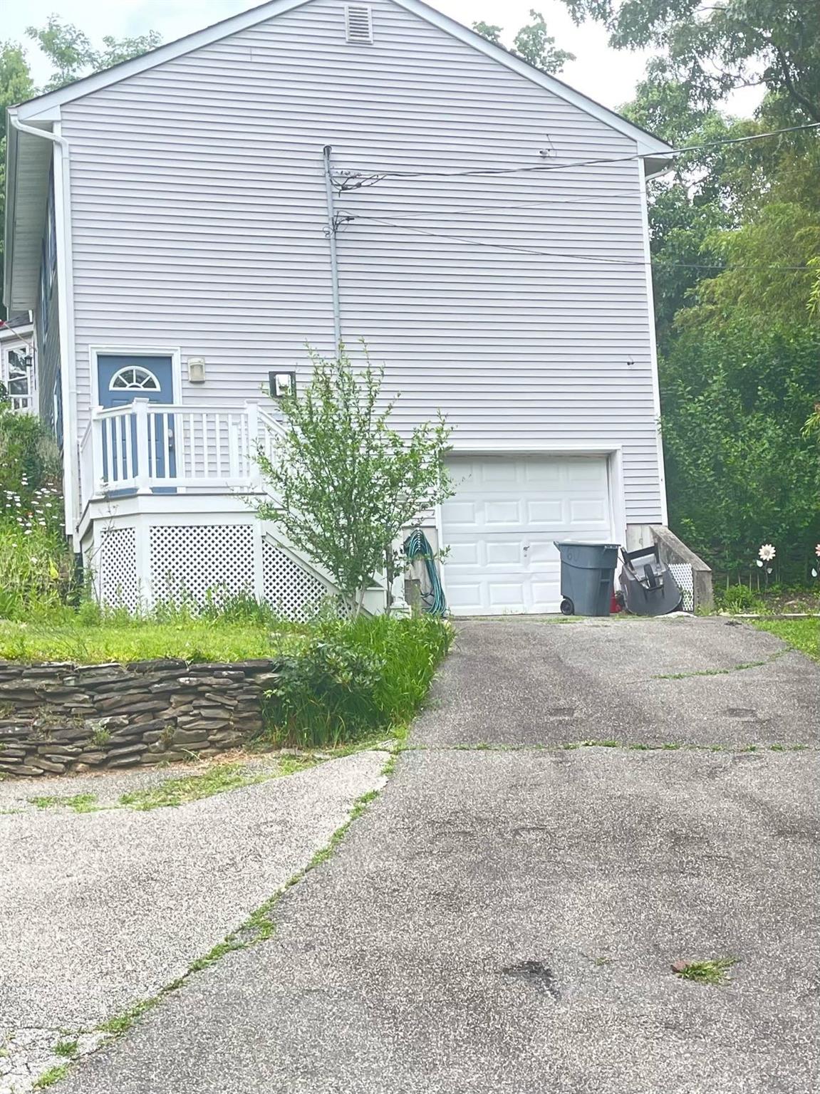 60 Aloma Road Rocky Point, NY 11778 - Photo 3 of 34 a front view of a house with a yard and garage