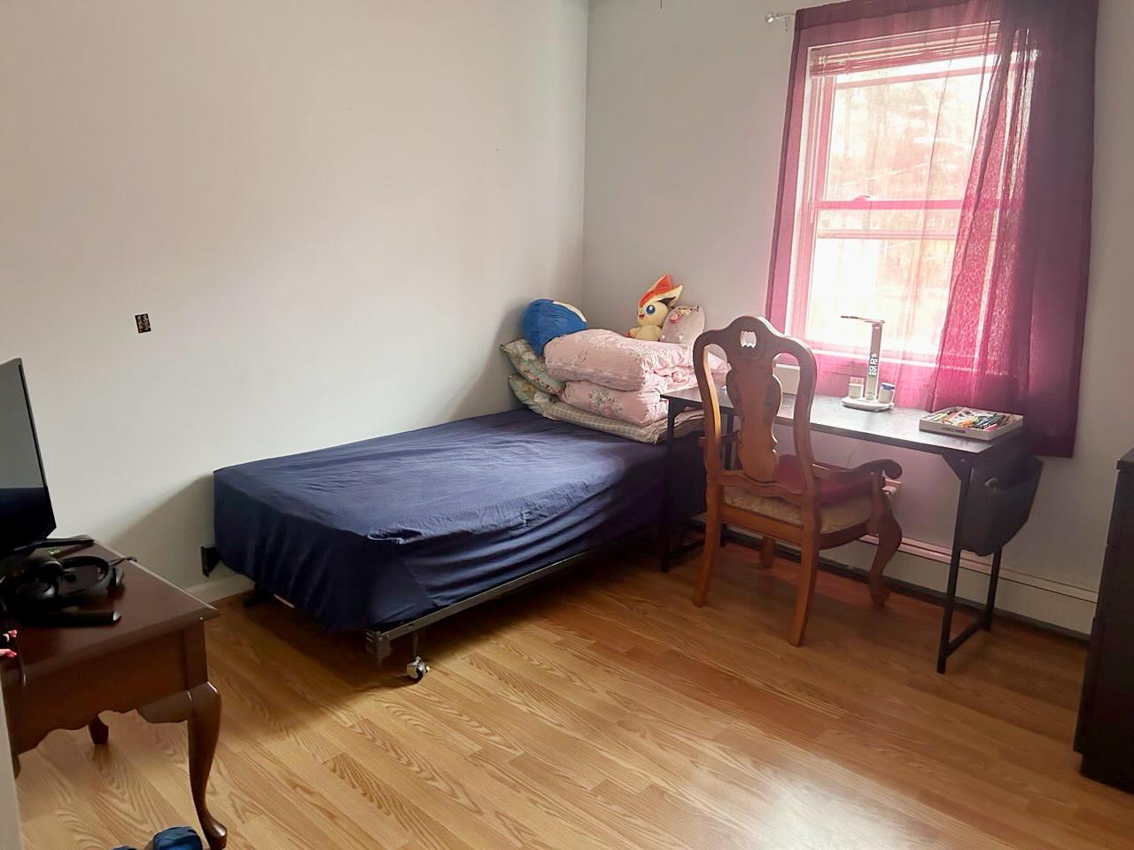 60 Aloma Road Rocky Point, NY 11778 - Photo 5 of 34 a bedroom with a bed and wooden floor