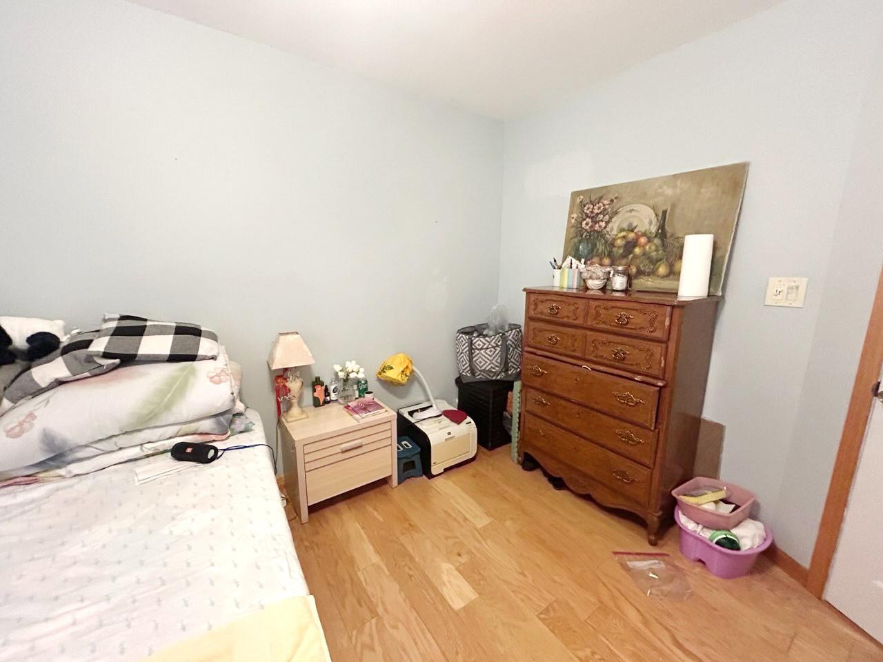 60 Aloma Road Rocky Point, NY 11778 - Photo 8 of 34 a bedroom with a bed and wooden floor