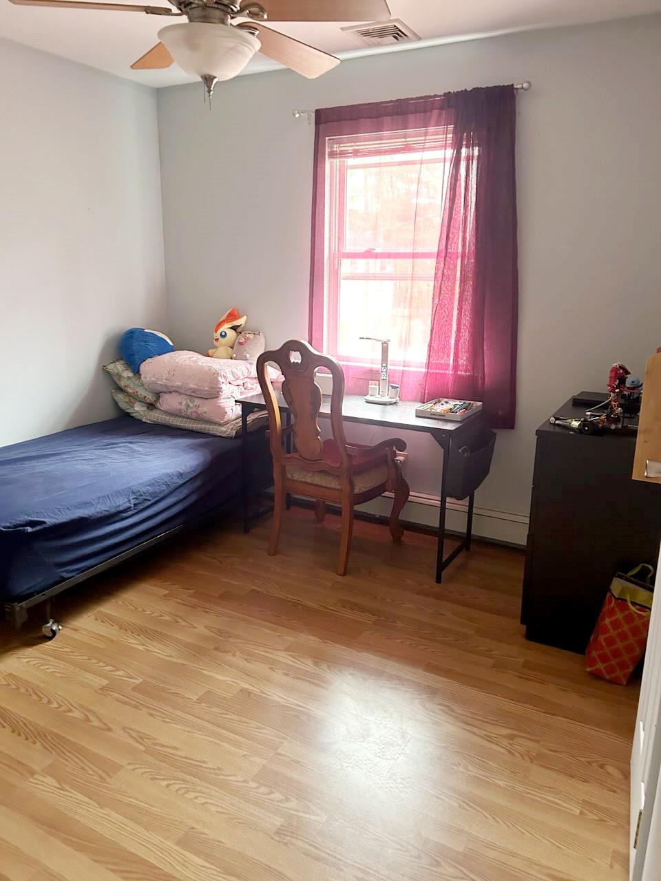 60 Aloma Road Rocky Point, NY 11778 - Photo 9 of 34 a bedroom with a bed and wooden floor