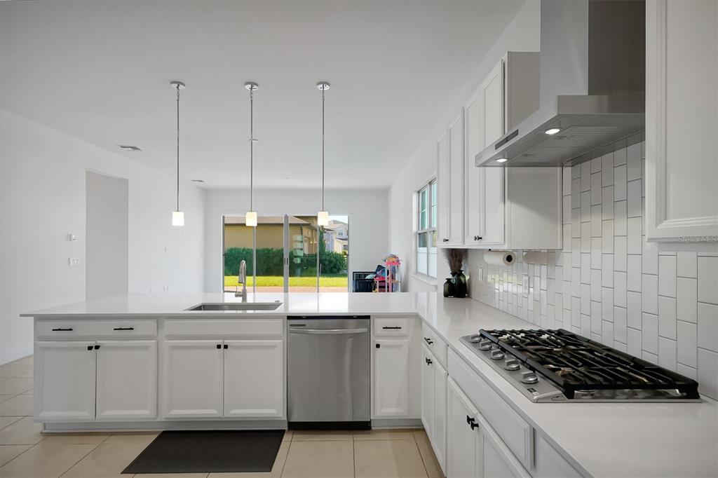 5200 Myrtleleaf Court St. Cloud, FL 34772 - Photo 13 of 59 a kitchen with white cabinets and appliances