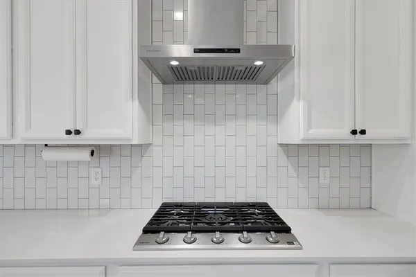 a living room with furniture and a air conditioner vent