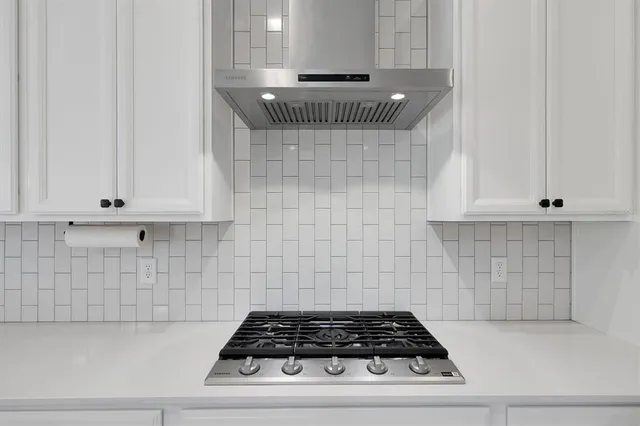 a living room with furniture and a air conditioner vent