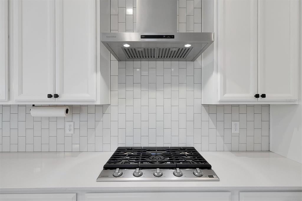 5200 Myrtleleaf Court St. Cloud, FL 34772 - Photo 14 of 59 a kitchen with a stove and white cabinets