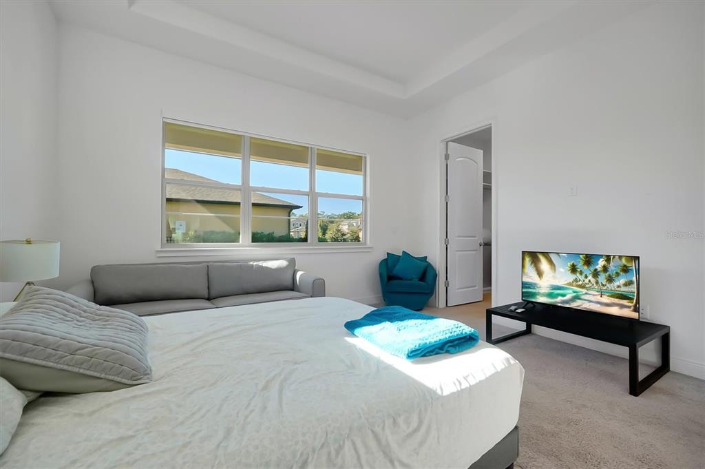 5200 Myrtleleaf Court St. Cloud, FL 34772 - Photo 17 of 59 a bedroom with a bed and a flat screen tv