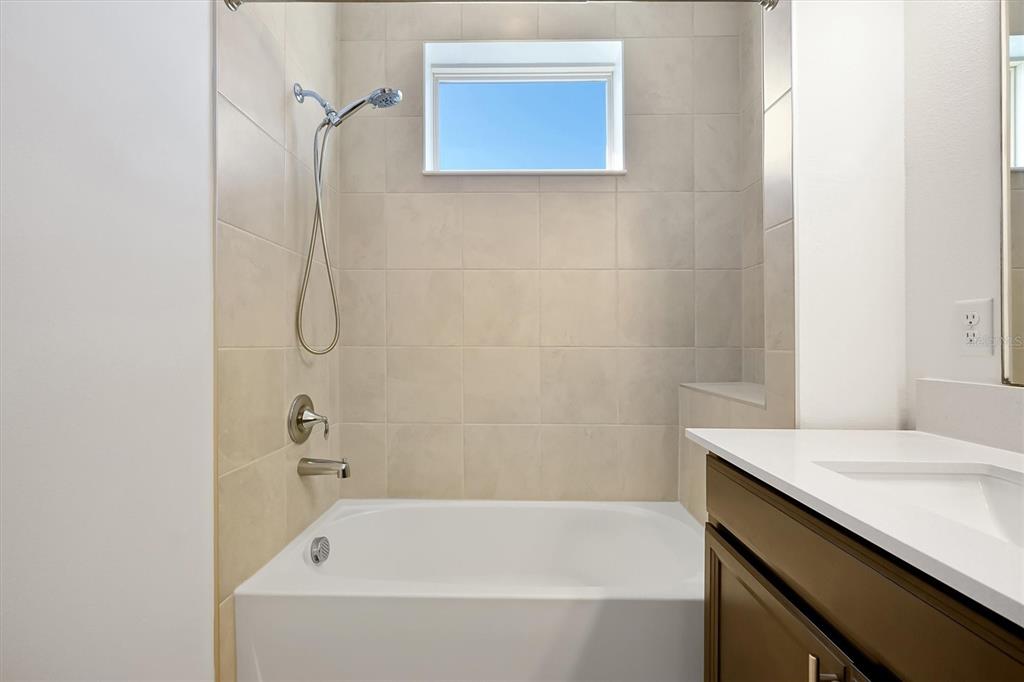 5200 Myrtleleaf Court St. Cloud, FL 34772 - Photo 31 of 59 a bathroom with a sink and a bathtub