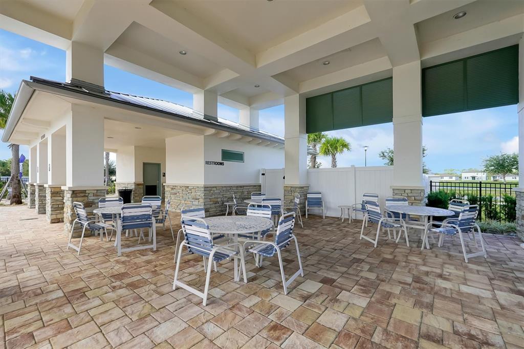 5200 Myrtleleaf Court St. Cloud, FL 34772 - Photo 55 of 59 a outdoor space with lots of tables a chair and a large window