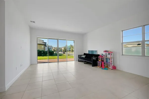 a large kitchen with stainless steel appliances a large counter top a refrigerator and a sink