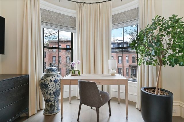 a view of a dining room with furniture and window