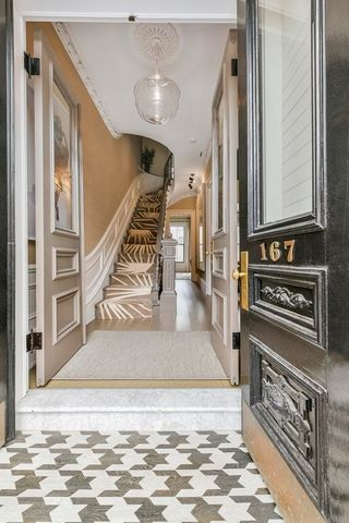 a view of an entryway with wooden floor