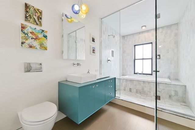 a bathroom with a toilet sink and mirror