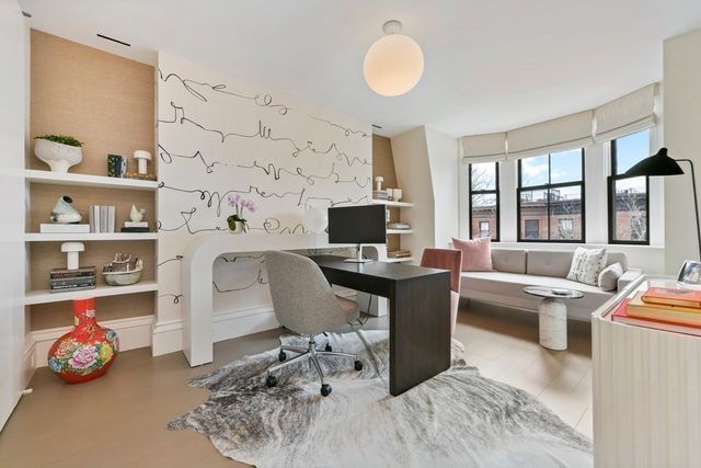 a view of a livingroom with workspace and a window