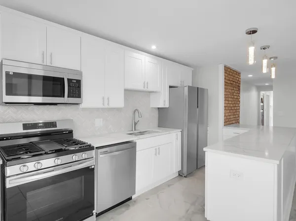 a kitchen with a sink stove and refrigerator