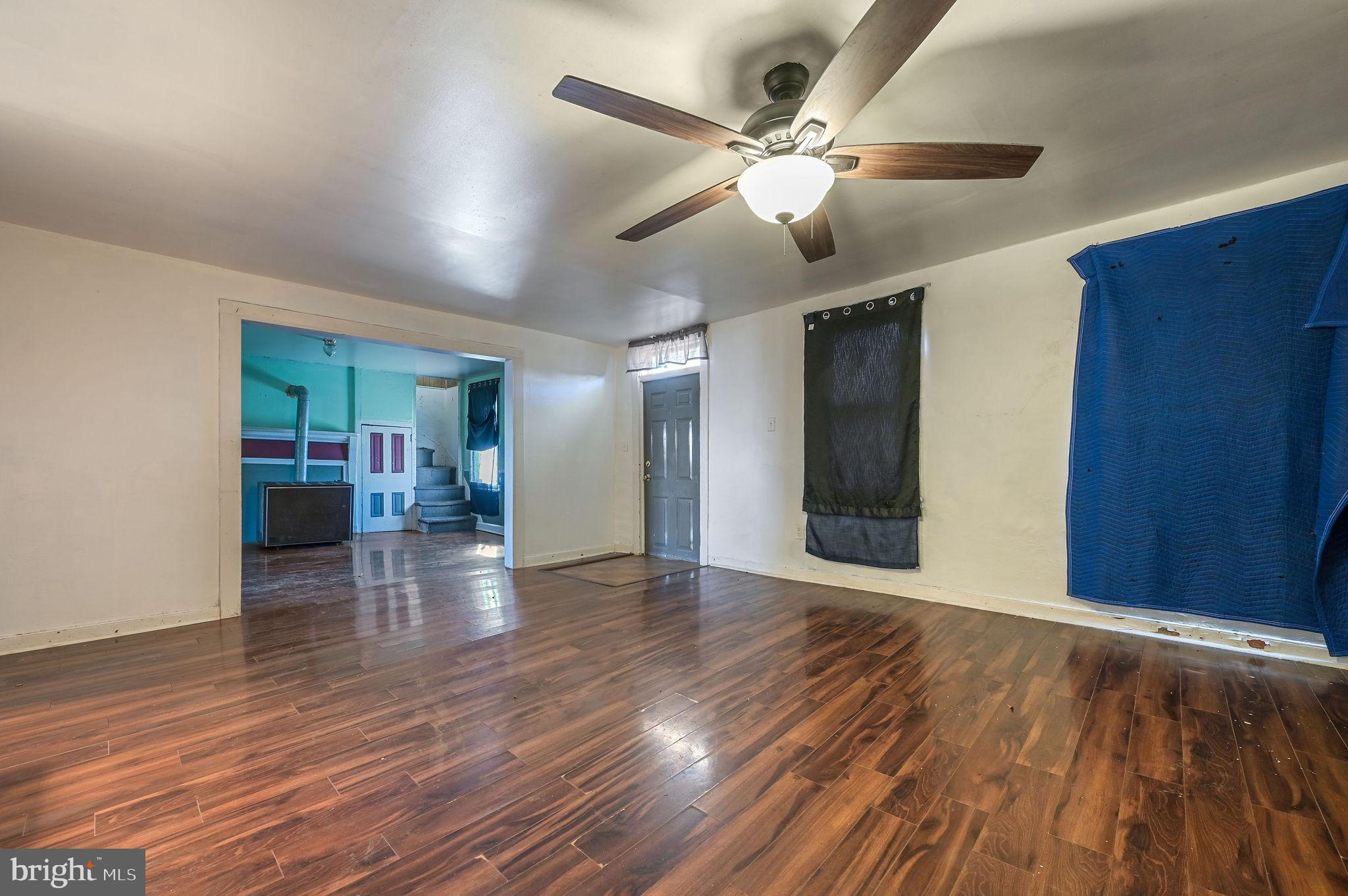 364 Main Street Little Creek, DE 19901 - Photo 17 of 21 a view of a hallway with wooden floor and a chandelier fan