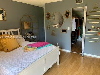 Crystal Lake Deerfield Beach, FL 33064 - Photo 13 of 13 a bedroom with a bed and closet