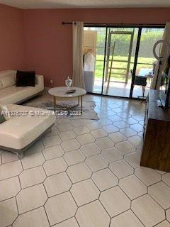 Crystal Lake Deerfield Beach, FL 33064 - Photo 2 of 13 a living room with a large window and a table