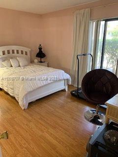 Crystal Lake Deerfield Beach, FL 33064 - Photo 8 of 13 a bedroom with a bed tv and a window