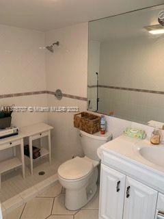 Crystal Lake Deerfield Beach, FL 33064 - Photo 10 of 13 a bathroom with a sink a toilet and shower
