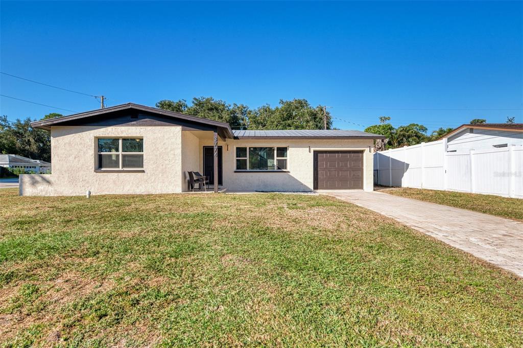3774 Wake Avenue Sarasota, FL 34240 - Photo 1 of 1 a front view of a house with a yard