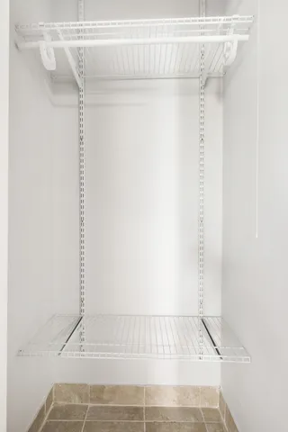 a view of walk in closet with clothes