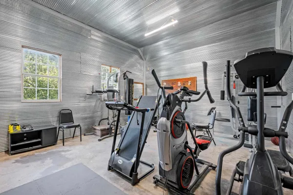 a view of a swimming pool with potted plants and seating space
