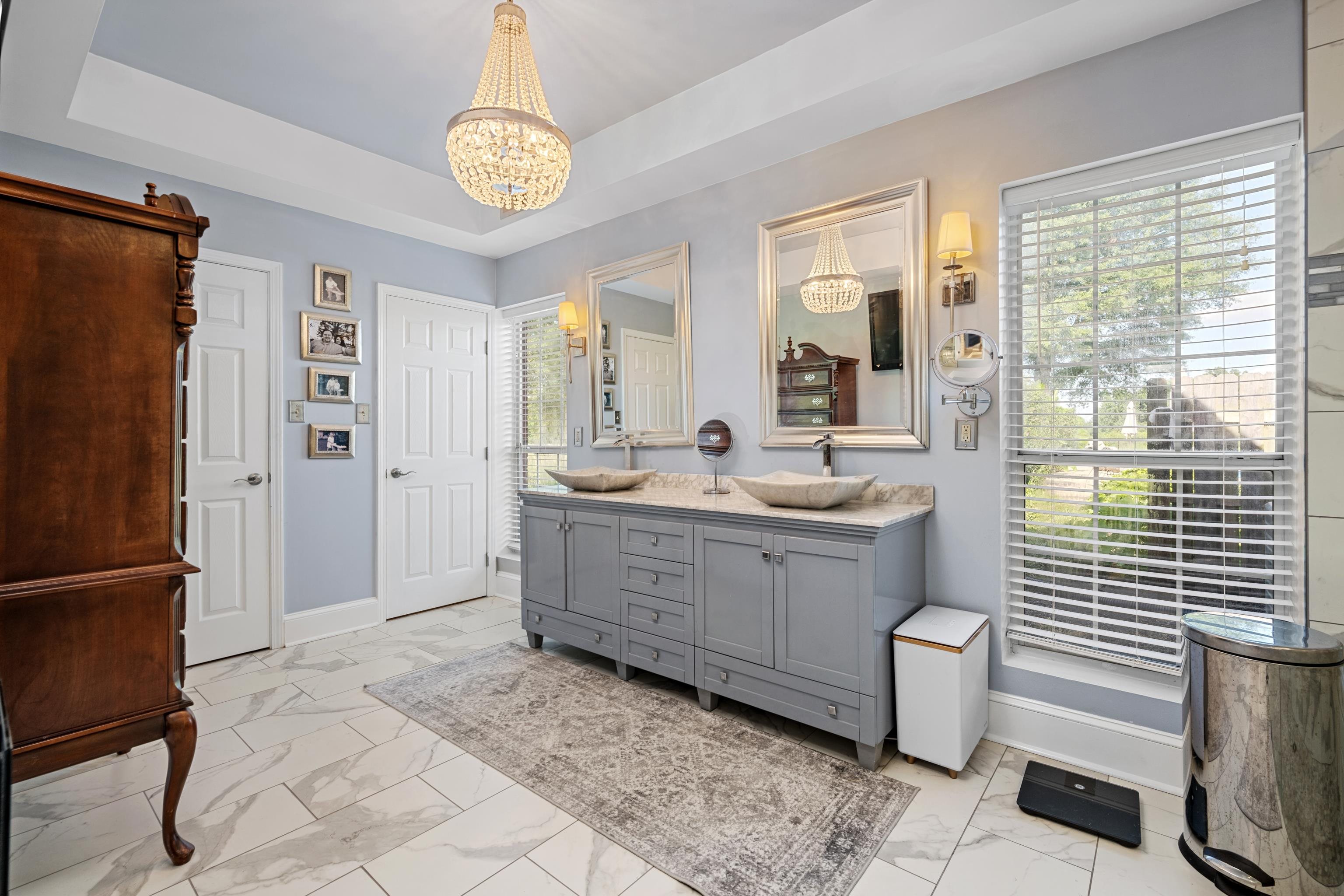 1354 Wilburn Road Michigan City, MS 38647 - Photo 40 of 40 a large white bathroom with a granite countertop sink a toilet a mirror and shower