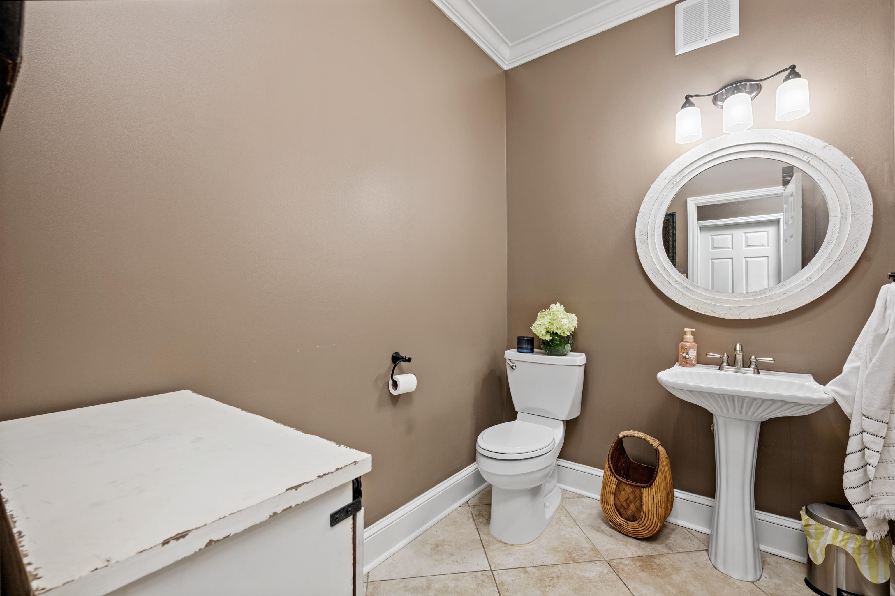 1354 Wilburn Road Michigan City, MS 38647 - Photo 9 of 40 a bathroom with a toilet a sink and a mirror