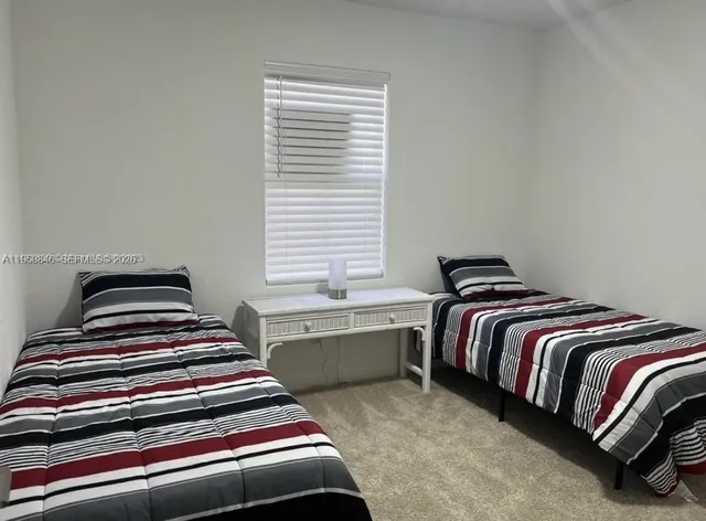 a bedroom with bed and a window