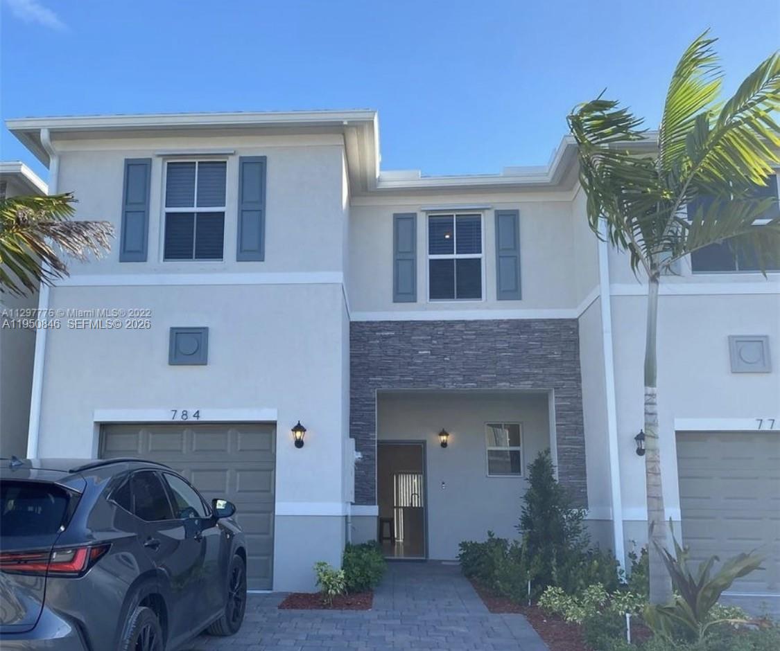 784 Southeast 19th Street, Unit 784 Homestead, FL 33034 - Photo 20 of 22 a front view of a house with garden