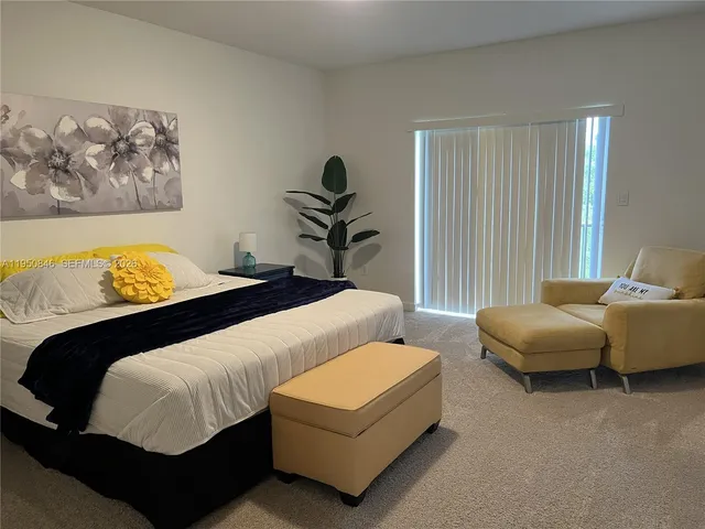 a bedroom with a bed and a couch