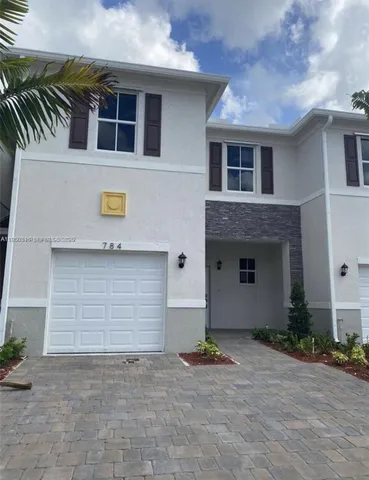 a front view of a house with garage